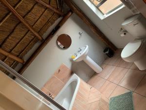 an overhead view of a bathroom with a toilet and sink at Vaal Triangle Guest House in Vanderbijlpark +17 photos
