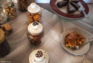 a table topped with jars and a plate of food at Agriturismo Tenuta Kyrios con piscina in Borgagne