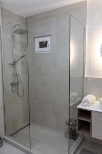 a shower with a glass door in a bathroom at I&I Apartments Lux in Kragujevac +24 photos
