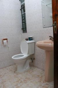 a bathroom with a toilet and a sink at Patty in Nairobi