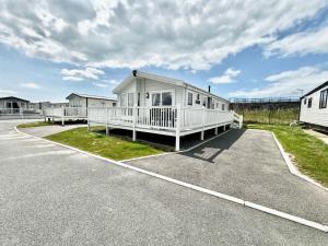 a white house is parked in a parking lot at Luxury Lodge at Parkdean Camber Sands Resort in Camber