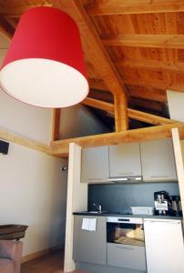 a red light hanging from a ceiling in a kitchen at L'Epicerie Du Monal in Sainte-Foy-Tarentaise