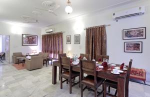 a dining room and living room with a table and chairs at Pratap Bhawan Homestay in Jaipur