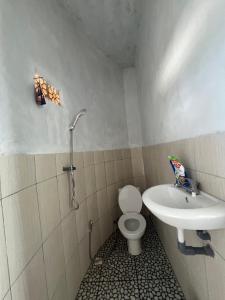 a bathroom with a toilet and a sink at Tera glamping bali 2 in Baturaja