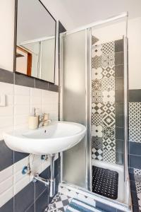 a bathroom with a sink and a shower at La casa di Luisa in Ronciglione