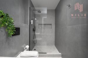 a bathroom with a shower with a toilet and a sink at Terra Suites, Nilie Hospitality MGMT in Thessaloniki +91 photos
