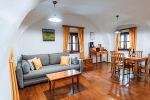 a living room with a couch and a table at Wine Grower's Mansion Zlati Gric in Slovenske Konjice