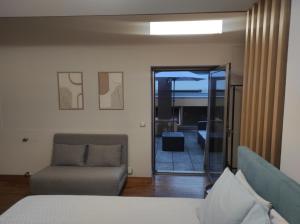 a living room with a couch and a chair at Casa Capela1 in Folgosa