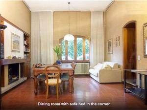 a living room with a dining room with a table and a couch at Casa Volta in Sansepolcro