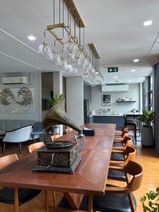 a long table in a room with chairs and lights at Poshtel 56 in Bangkok
