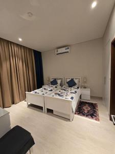 a bedroom with a large white bed in a room at LZ Villa in Wādī Khasbar