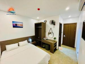a bedroom with a bed and a television in it at Sunrise Hotel Thiên Cầm in Hà Tĩnh