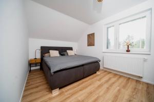 a bedroom with a large bed and a window at Apartmány Na Satině in Malenovice +60 photos