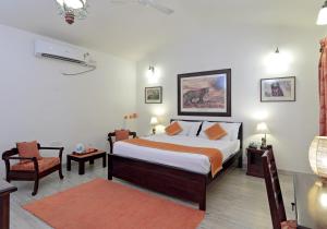 a bedroom with a bed and a chair at Pratap Bhawan Homestay in Jaipur