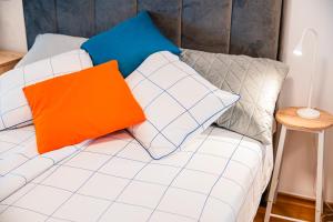 a white couch with two pillows on it at Fleksibilni SelfCheckIns 168 - Zagreb - Studio - Parking - Lođa in Zagreb