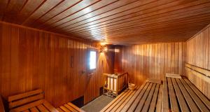 an empty wooden sauna with a toilet in it at PLAZA INN Zwickau in Zwickau