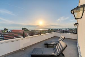 a balcony with two chairs and a table on a building at Apartment Midi in Vir