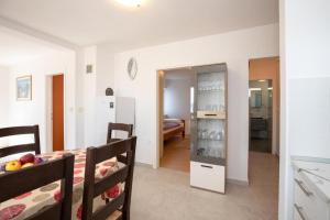 a kitchen and a living room with a bedroom at Apartments Ruza in Porat