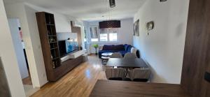 a living room with a table and a couch at Apartment Lazarus with garage Banja Luka in Banja Luka