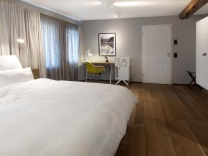 Postel nebo postele na pokoji v ubytování DORMERO Hotel Schwäbisch Hall + 3 fotografie