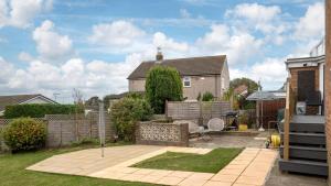 a yard with a patio and a house at Awel Fryn in Colwyn Bay