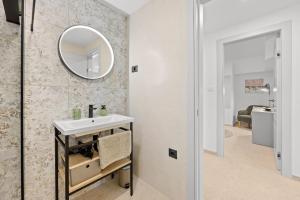 a bathroom with a sink and a mirror on the wall at Apartment Gradina in Vodnjan