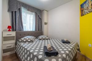 a small bedroom with two beds and a window at House Nina in Pazin +30 photos