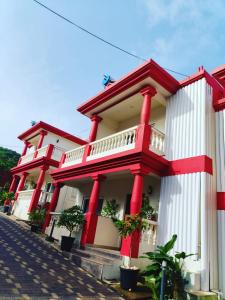a large building with red and white at Villa with Pool at Sea Horizon Luxurious Villas in Mandrem