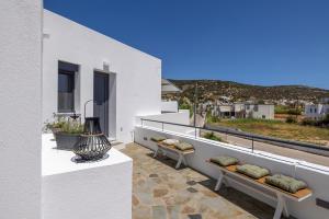 a balcony with benches and a view of the city at Aphrodite's Refuge in Galissas