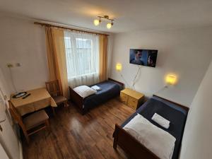 a small room with a bed and a small table at Hotel Eden 24h in Rzeszów
