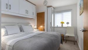 a bedroom with a large bed and a window at Seahorses in Conwy