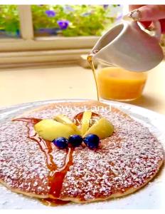 a pancake with syrup and fruit on a table at Baggot Court Townhouse in Dublin