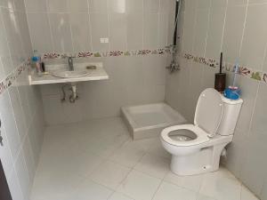 a small bathroom with a toilet and a sink at Elhlal luxury apartment in Hurghada