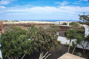a view of the beach from the balcony of a resort at Habitaciones Doña Cris in Puerto del Carmen