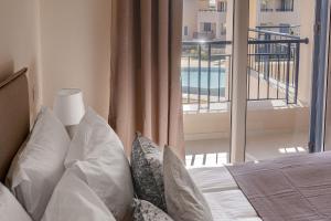 Un dormitorio con una cama con vista a un balcón. en Phaedrus Living Seaside Thalassa Cretan 203, en Módhion