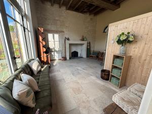 a living room with a couch and a fireplace at Demeure de Beaulieu in Le Coudray-Macouard