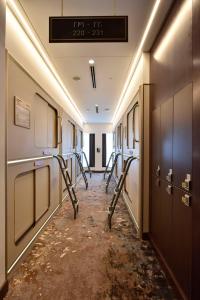 a corridor of a hospital hallway with a row of machines at Bahrain Airport Hotel Airside Hotel for Transiting and Departing Passengers only in Muharraq
