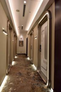 a corridor of an empty hallway in a building at Bahrain Airport Hotel Airside Hotel for Transiting and Departing Passengers only in Muharraq
