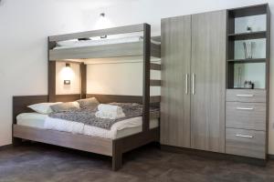 a bedroom with a bunk bed and a cabinet at Apartmaji na Pošti in Podsreda