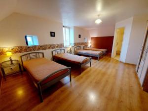 a room with three beds and wooden floors at Les Preaux in Carelles +26 photos