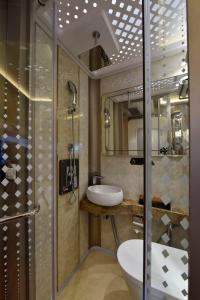 a bathroom with a toilet and a sink and a shower at Bahrain Airport Hotel Airside Hotel for Transiting and Departing Passengers only in Muharraq