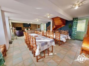 a dining room with a table and chairs at La Maison de la pêche in Carelles