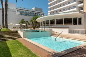a swimming pool in front of a building at tent Playa de Palma in Playa de Palma