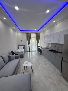 a living room with a blue light on the ceiling at A3 Apartments in Velipojë +25 photos