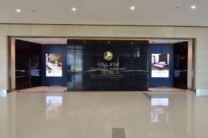 a room with two glass doors in a building at Bahrain Airport Hotel Airside Hotel for Transiting and Departing Passengers only in Muharraq