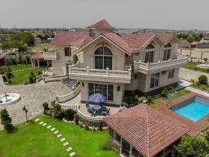 an aerial view of a large house with a swimming pool at Luxury Guest House Near Islamabad Airport - AH Royal Resort in Islamabad