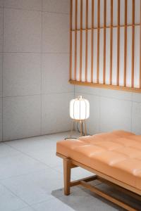 a lamp sitting next to a bed in a room at KIORI Collection Shinmachi in Kyoto +75 photos