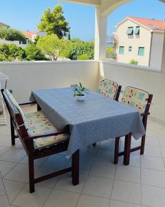 a table and chairs with a blue table cloth on a balcony at Villa Tajnikov in Hvar