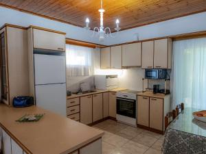 a kitchen with white appliances and a counter top at Villa Platanos in Kanali
