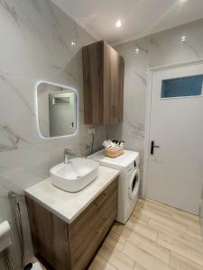 a bathroom with a sink and a washing machine at Villa Platanos in Kanali +13 photos
